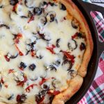 Say no to take out pizza and make you own easy Deep Pan Pizza made in a cast-iron skillet. Layers of meats, cheeses, and a golden crust.
