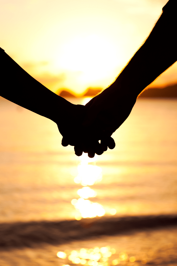 holding hands by the water